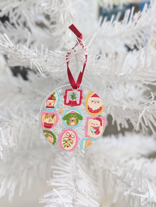 Decorative Christmas acrylic ornament with colorful designs on a white tree.